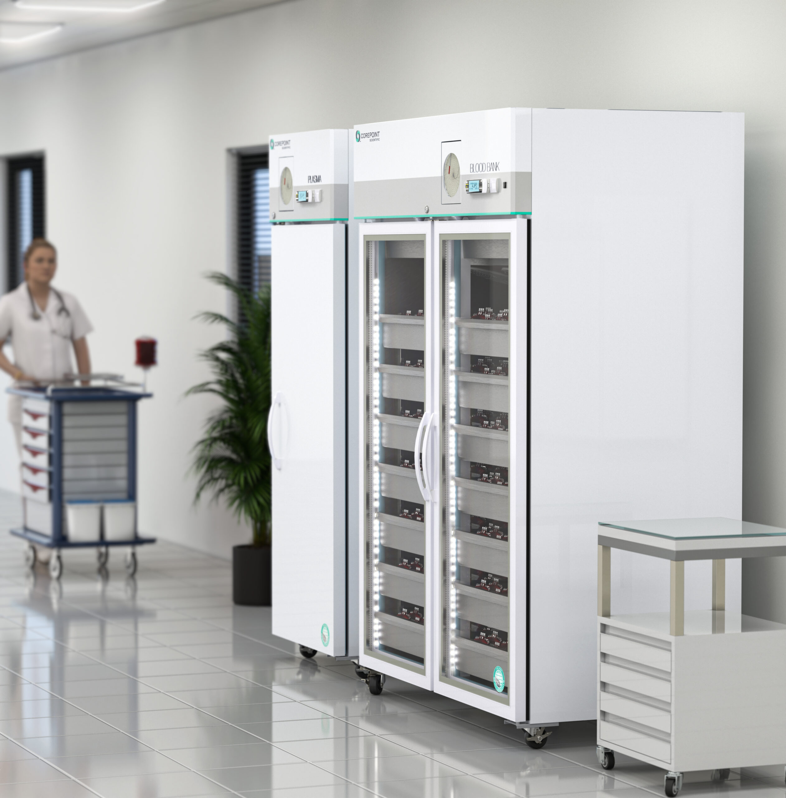 A hospital hallway with a nurse pushing a medication cart past two large, glass-door medical refrigerators filled with trays. A small rolling table stands nearby. The setting appears clean and modern.